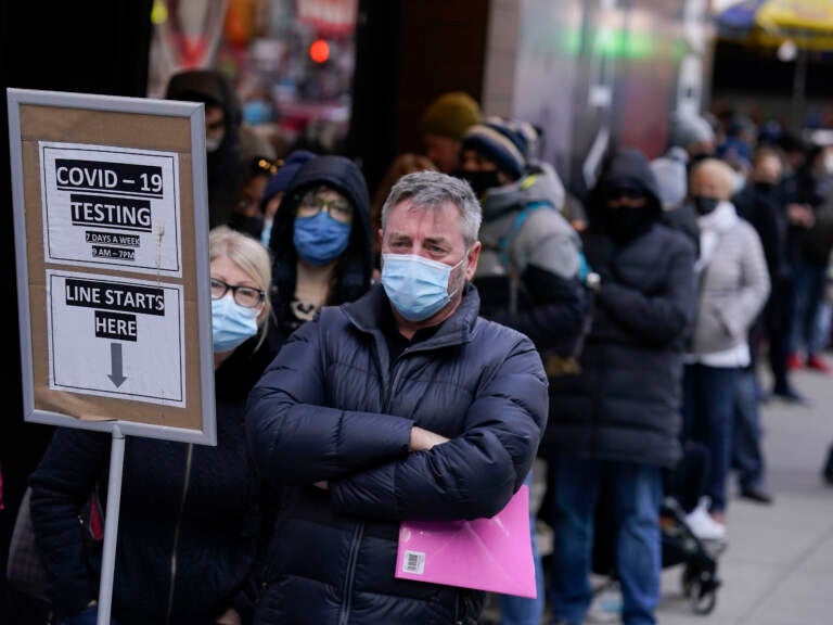 People wait in line at a COVID-19 testing site in Times Square