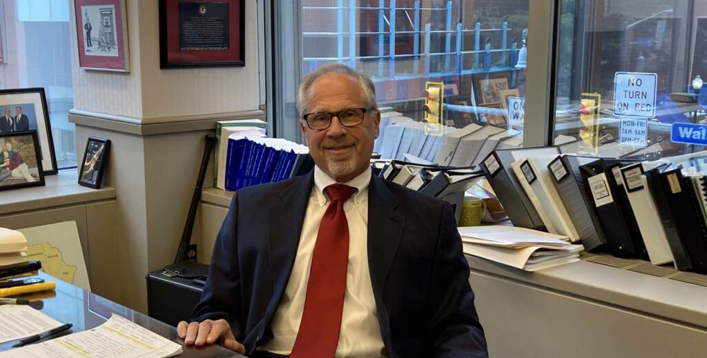 Bruce Brandler poses for a photo in his office