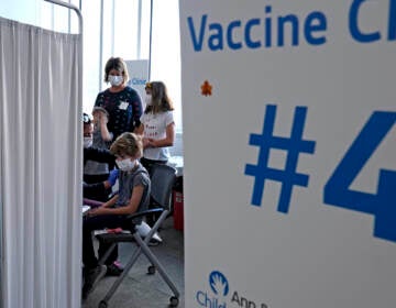 Graham Roark receives the Pfizer COVID-19 vaccine for children from Lurie Children's hospital registered nurse Virginia Scheffler