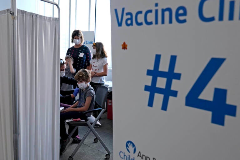 Graham Roark receives the Pfizer COVID-19 vaccine for children from Lurie Children's hospital registered nurse Virginia Scheffler