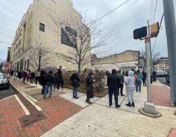 People wrap around the block while waiting in line for COVID-19 testing