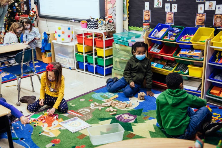 Inside the classrooms, teachers have masked the crumbling building with brightly colored rugs, decorations, reading and play nooks, and educational materials