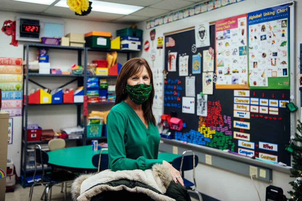 Maria Szczecina stands behind the desk chair in her classroom adorned with brightly colored educational tools. She is one of two Title 1 Reading teachers at the school. She used the word “triage” to describe coping with inadequate funding and the state of the facility