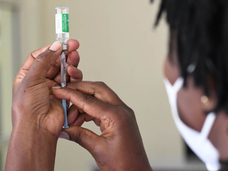 A Kenyan health worker prepares to administer a dose of the Oxford/AstraZeneca vaccine