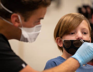 A nurse tests a student for COVID-19 at Brandeis Elementary School in Louisville, Ky. (Jon Cherry/Getty Images)