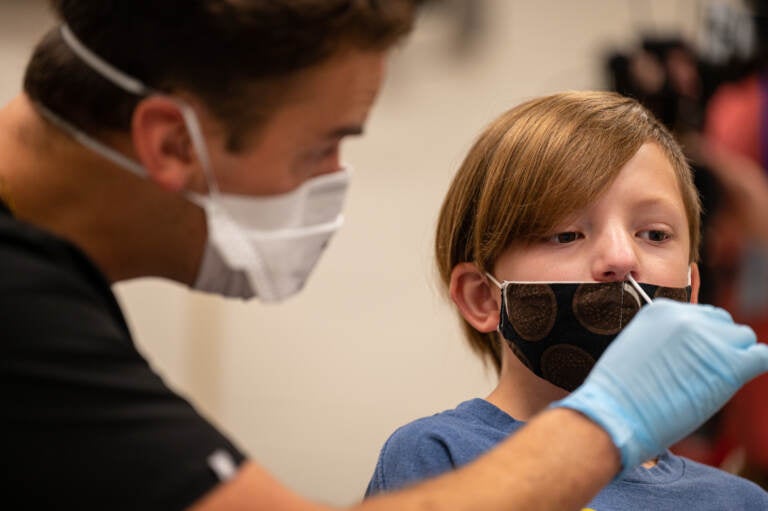 A nurse tests a student for COVID-19 at Brandeis Elementary School in Louisville, Ky. (Jon Cherry/Getty Images)