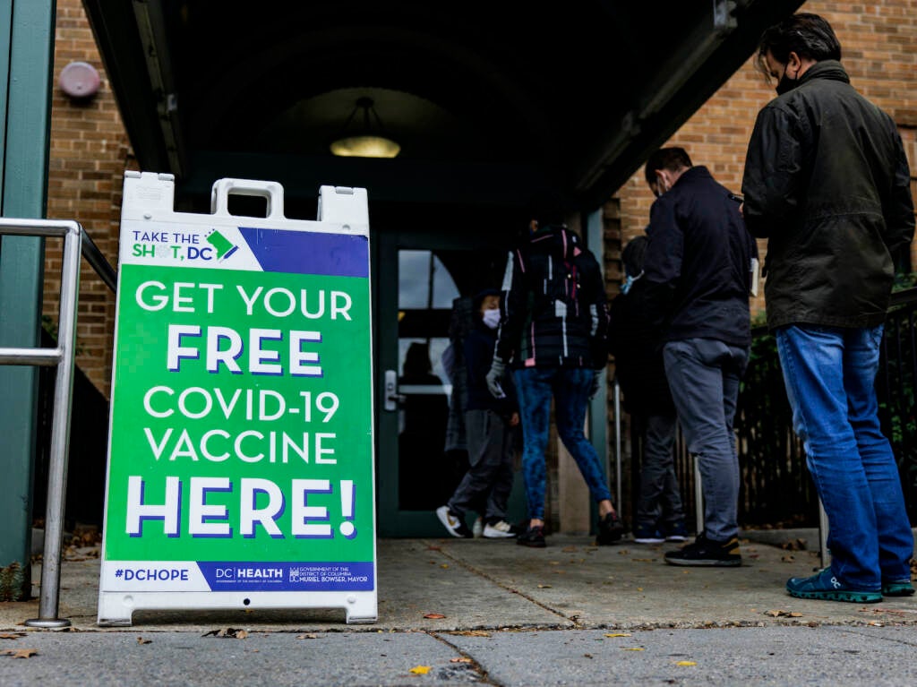 People line up outside of a free COVID-19 vaccination site