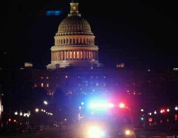 A police car drives away from the Capital after thousands of Donald Trump supporters stormed the United States Capitol building following a 