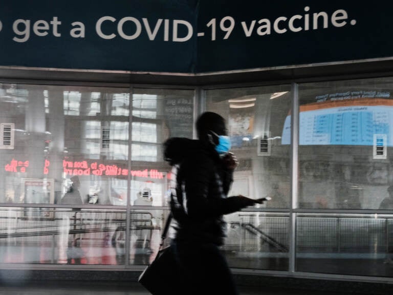 A sign urges people to get the Covid vaccine at the Staten Island Ferry terminal on November 29, 2021 in New York City. Across New York City and the nation, people are being encouraged to get either the booster shot or the Covid-19 vaccine, especially with the newly discovered omicron variant slowly emerging in countries around the world. While there are no cases yet discovered in America, New York's governor Kathy Hochul has declared a state of emergency ahead of the risk of COVID-19 spikes as winter sets in. (Photo by Spencer Platt/Getty Images)