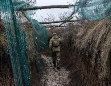 A Ukrainian soldier, who goes by the nickname Chorny, walks in a trench on the front line on December 12, 2021 in Zolote, Ukraine.  (Brendan Hoffman/Getty Images)