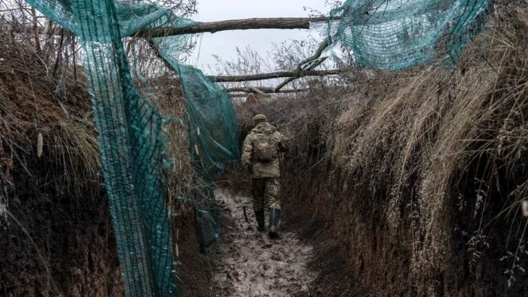 A Ukrainian soldier, who goes by the nickname Chorny, walks in a trench on the front line on December 12, 2021 in Zolote, Ukraine.  (Brendan Hoffman/Getty Images)