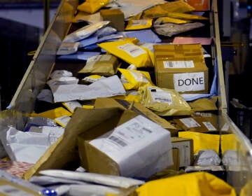 Parcels jam a conveyor belt at the United States Postal Service sorting and processing facility