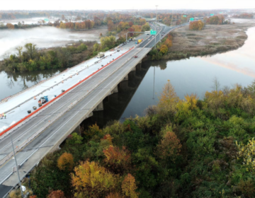 Aerial view of I-95, including the river beneath it and trees on the sides of the highway.