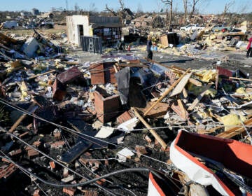 People retrieve items from a destroyed law office