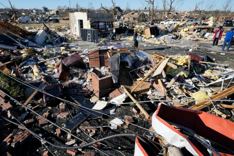 People retrieve items from a destroyed law office