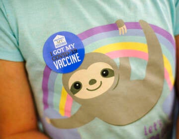 A closeup of a child's t-shirt, with a sticker visible that says, 
