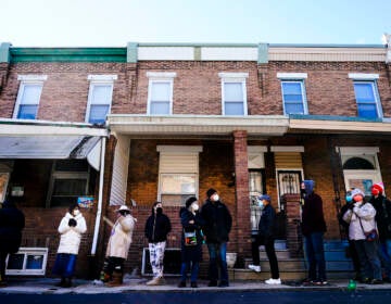 City residents wait in a line extending around the block to receive free at-home rapid COVID-19 test kits in Philadelphia