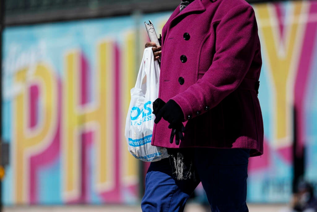A pedestrian carries a plastic bag in Philadelphia