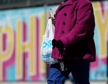 A pedestrian carries a plastic bag in Philadelphia