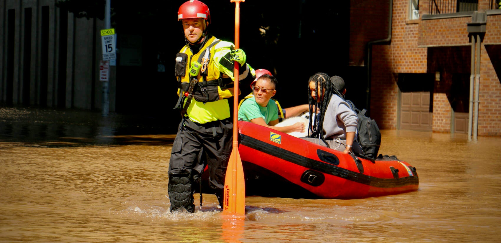 Philadelphia Fire Department personnel carry residents of the Riverwalk apartments to safety at 22nd and Arch streets after they were trapped by flood waters