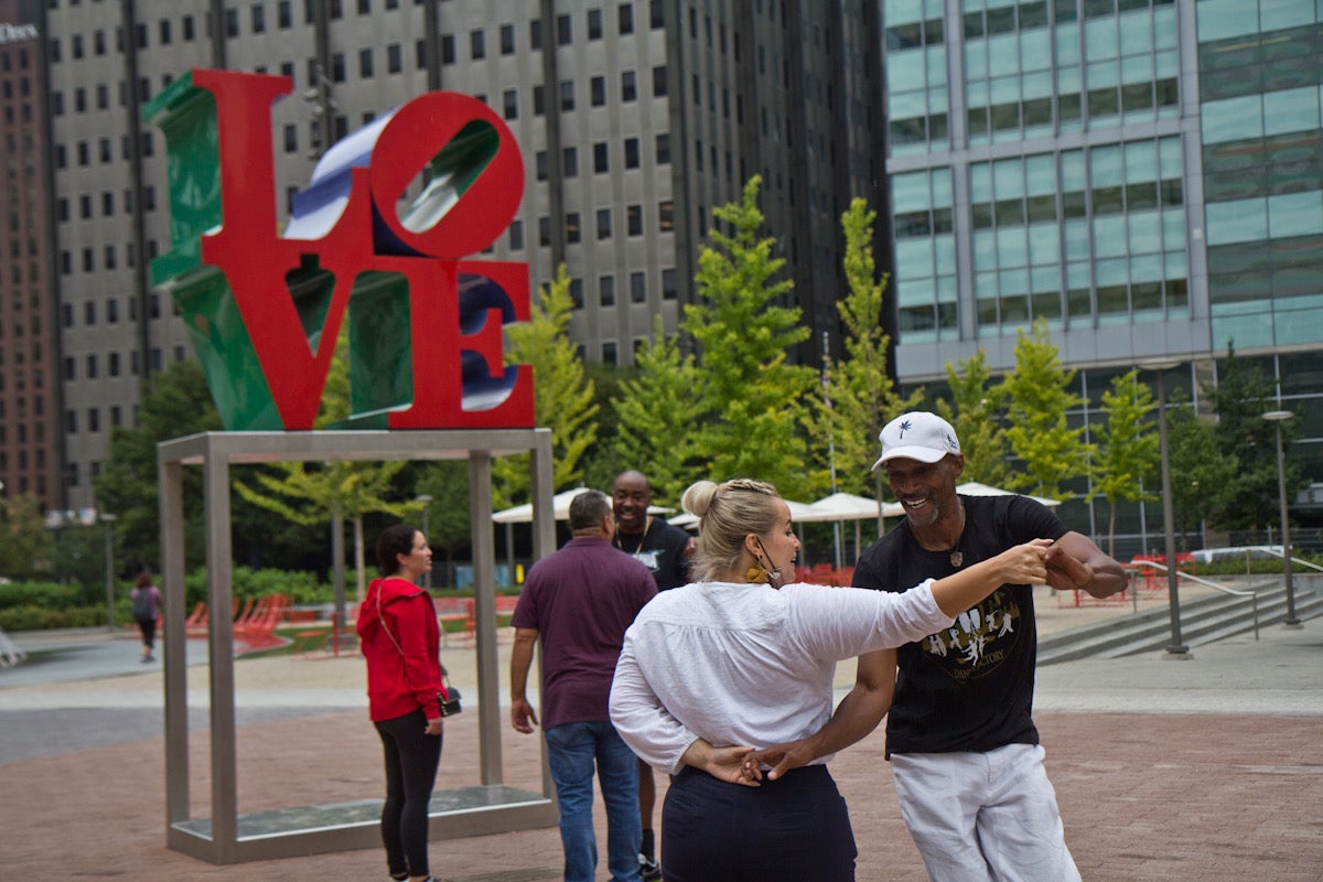 Jennifer Pieretti stops on her lunch break to dance with Mark ‘Maestro Flaco’ Best at LOVE Park in Center City, Philadelphia