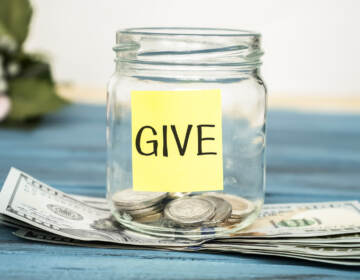 Coins in a glass jar with the word 