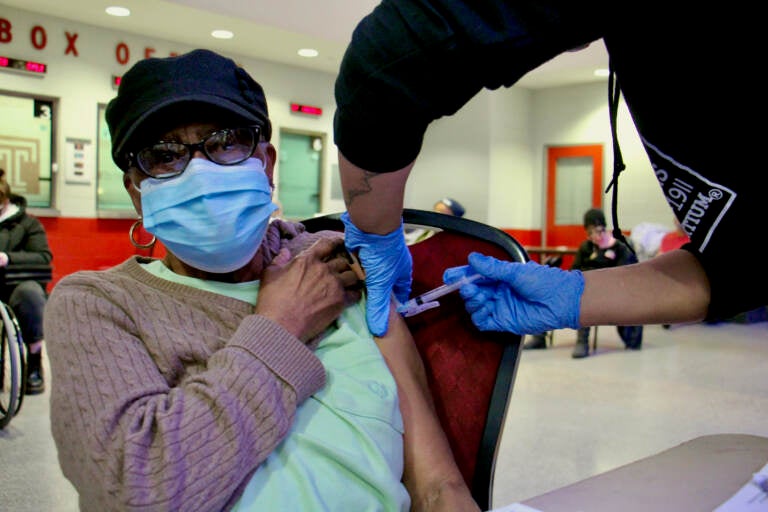 Edna Evans, 88, gets a COVID-19 vaccination at the Liacouras Center at a vaccine clinic organized by the Black Doctors Consortium.