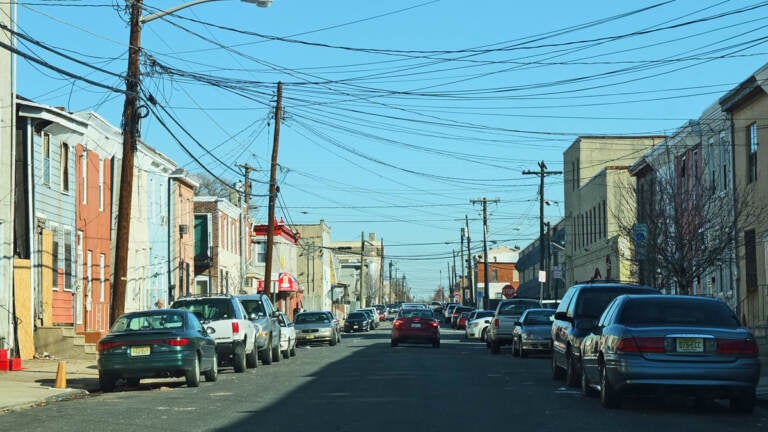 A view of a street with houses lining each side.