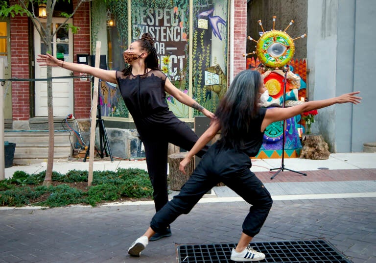 Caitlin Green and Ani Gavino perform on Maplewood Mall in Germantown in March 2021, as part of Painted Bride’s ''Grace Period: A Community Ritual for Collective Healing.''  (LaNeshe Miller-White)
