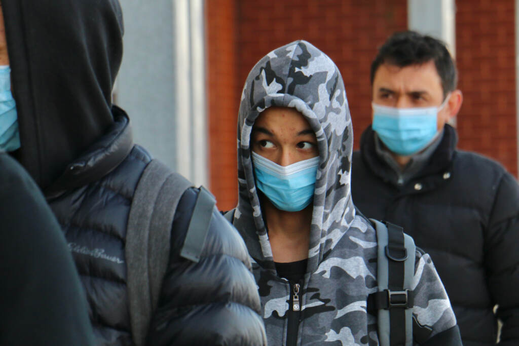 Ali Wahaj Mosakhil waits in line with other students to enter Samuel Fels High School