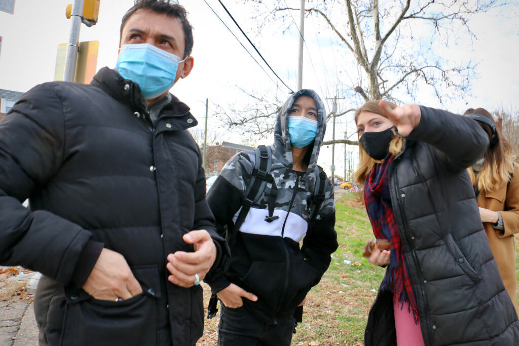 Michelle Ferguson shows Ali Wahaj Mosakhil and his father, Esmatullah, a bus route