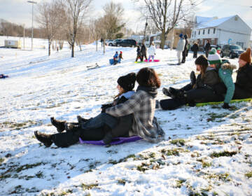 Children sled on a slope in Williamson Park in Morrisville. (Emma Lee/WHYY)