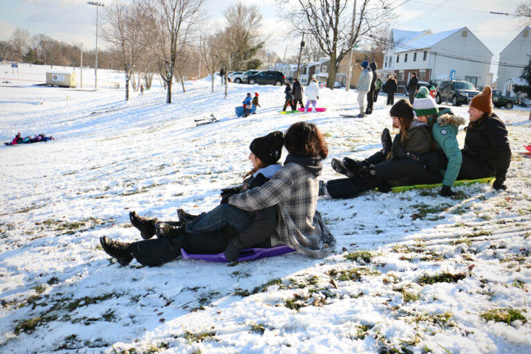 Children sled on a slope in Williamson Park in Morrisville. (Emma Lee/WHYY)