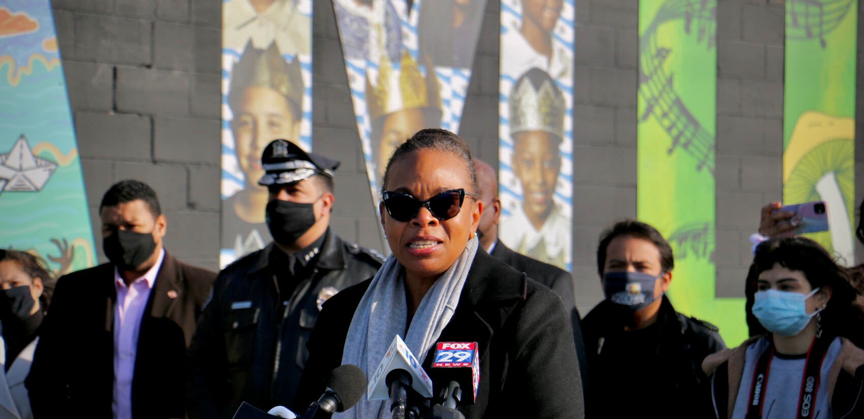 Former Camden Mayor Dana Redd, now chair of the Camden Community Partnership, speaks at the dedication of the Camden Invincible mural. (Emma Lee/WHYY)