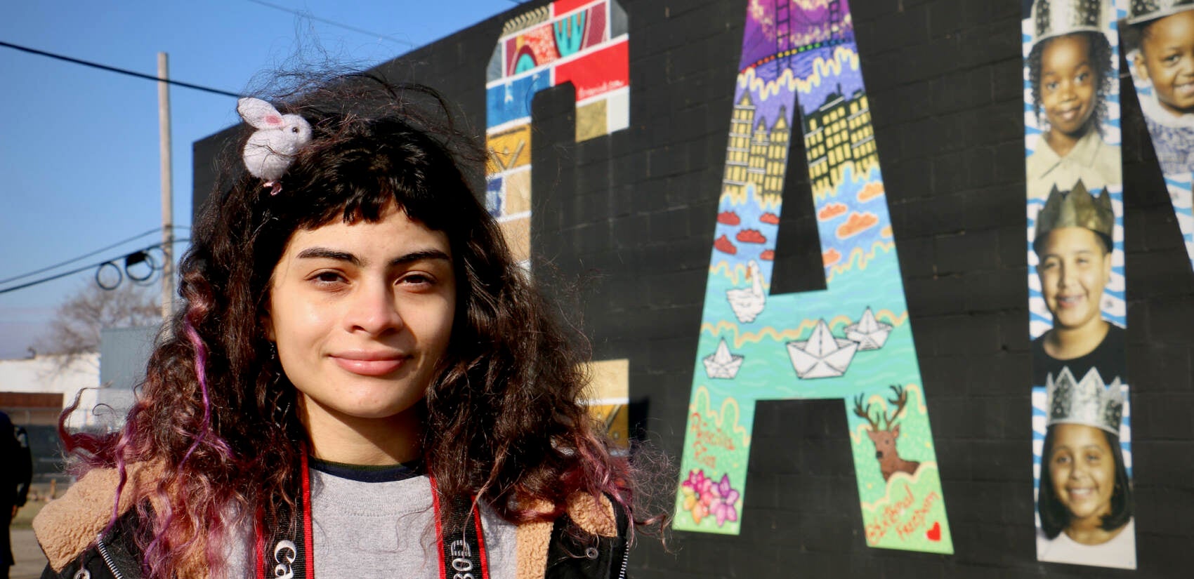 Priscilla Rios, a lifelong Camden resident, made both the A and E for the ''Camden Invincible'' mural. Her A depicts the city’s natural areas, its abandoned buildings, and the spectacular view from the Camden waterfront. (Emma Lee/WHYY)
