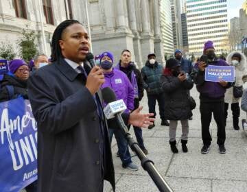 Rep. Malcolm Kenyatta stands with members of SEIU outside City Hall in Philadelphia on Jan. 19, 2022. (Tom MacDonald/WHYY)