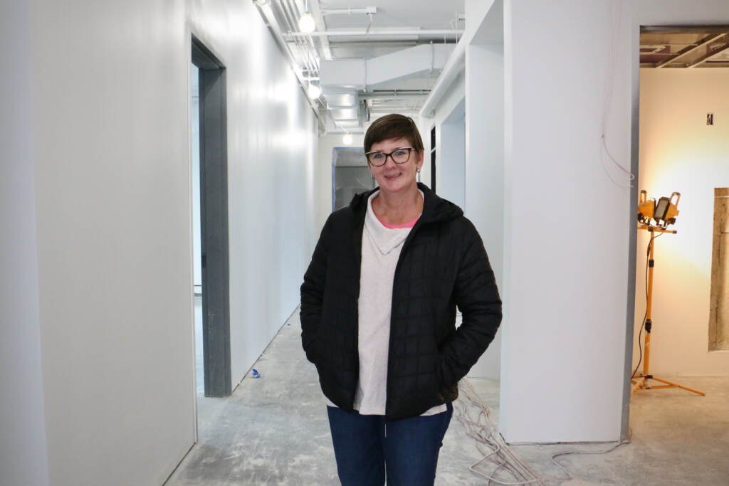 Clay Studio Executive Director Jennifer Martin stands in the fourth floor of the nearly completed new studio on North American Street. (Emma Lee/WHYY)