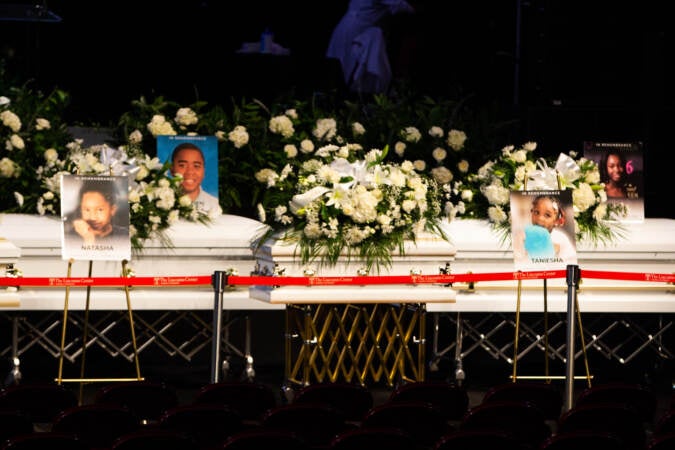 Caskets are seen during a funeral at Temple's Liacouras Center