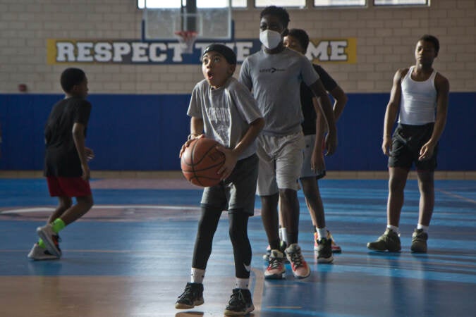 The Give And Go 12 and Under basketball athletes run drills at Vaux Big Picture High School