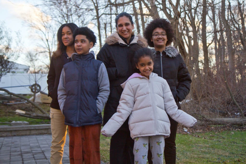 Amina Malik (center), with her children (from left) Rabiyyah, 13, Sadat, 10, Raina, 8, and Ruqayyah, 18, in their yard in Northeast Philadelphia.