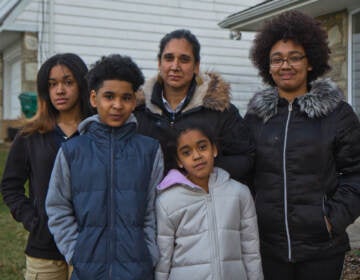 Amina Malik (center), with her children (from left) Rabiyyah, 13, Sadat, 10, Raina, 8, and Ruqayyah, 18, in their yard in Northeast Philadelphia.