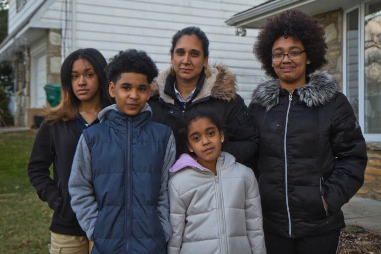 Amina Malik (center), with her children (from left) Rabiyyah, 13, Sadat, 10, Raina, 8, and Ruqayyah, 18, in their yard in Northeast Philadelphia.