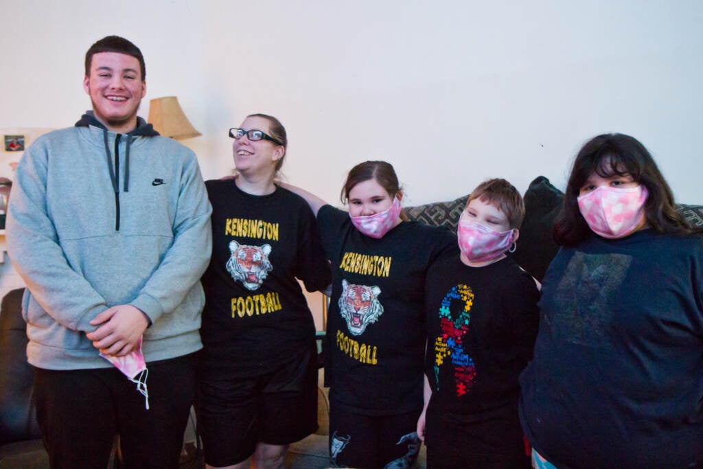 Stefanie Marrero (second from left), with her children (from left) John, 15, Bailey, 9, Parker, 8, and Jazmine, 10, at their home with their two dogs, Kiley and Hercules.