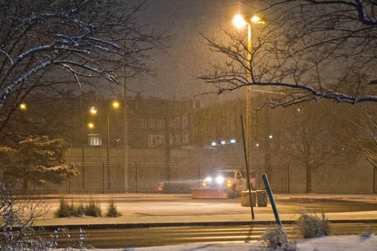 A plow truck waits for snow fall to accumulate in Philadelphia on January 28, 2022. (Kimberly Paynter/WHYY)