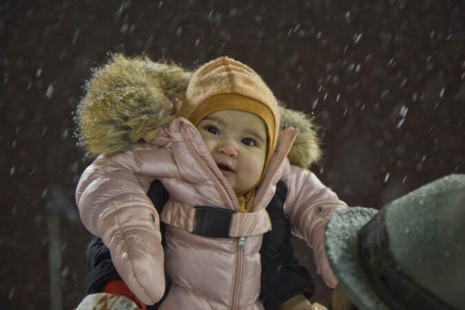 5 month-old Claudia plays in the snow for the first time at Palumbo Recreation Center in South Philadelphia on Jan. 28, 2022. (Kimberly Paynter/WHYY)