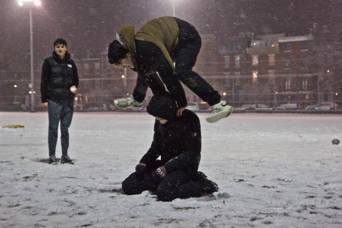 Teenagers play in the snow at Palumbo Recreation Center in South Philadelphia on Jan. 28, 2022. (Kimberly Paynter/WHYY)