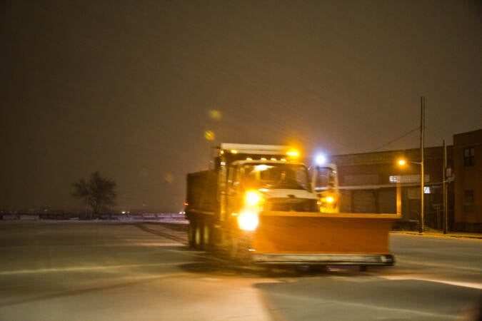 A plow truck waits for snow fall to accumulate in Philadelphia on Jan. 28, 2022. (Kimberly Paynter/WHYY)