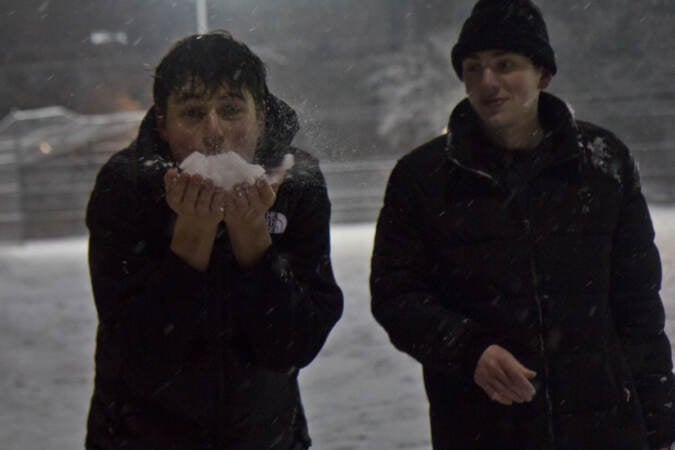 Teenagers play in the snow at Palumbo Recreation Center in South Philadelphia on Jan. 28, 2022. (Kimberly Paynter/WHYY)