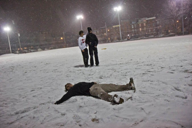 Teenagers play in the snow at Frank Palumbo Recreation Center in South Philadelphia on Jan. 28, 2022. (Kimberly Paynter/WHYY)