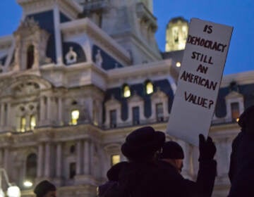 About 40 people gathered in Philadelphia’s Thomas Paine Plaza at a candlelight vigil remembering the attacks on the U.S. Capital a year later, on January 6, 2022. (Kimberly Paynter/WHYY)
